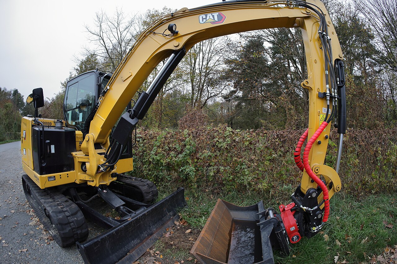 CAT 306 CR mini excavator parked at a work site